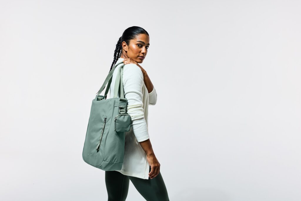Woman with sage green tote bag