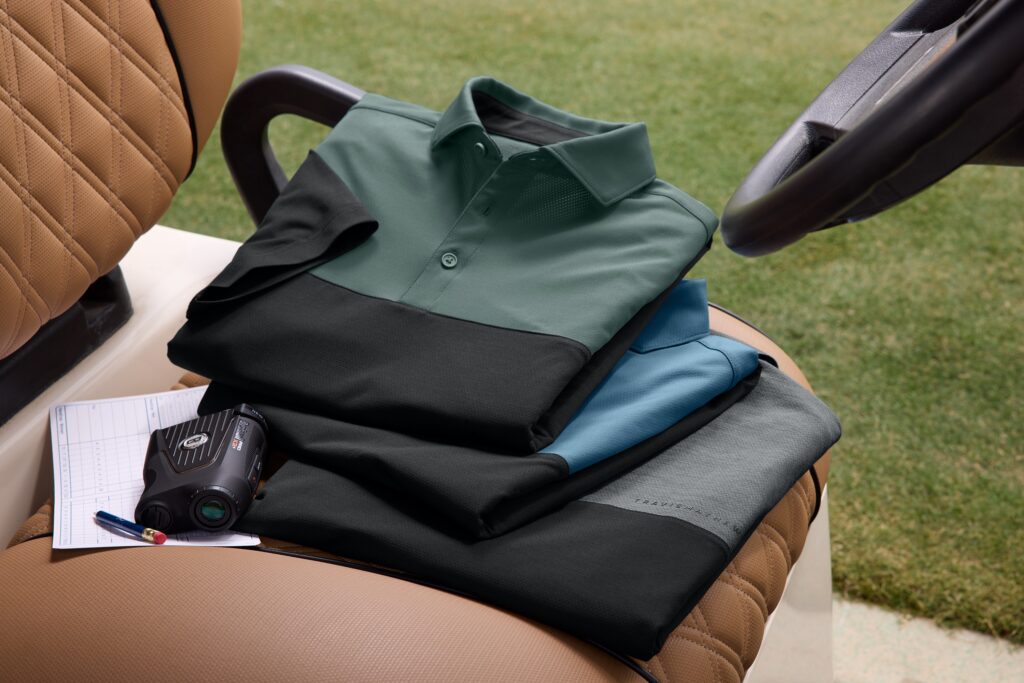 Stack of folded black quarter-zip jackets